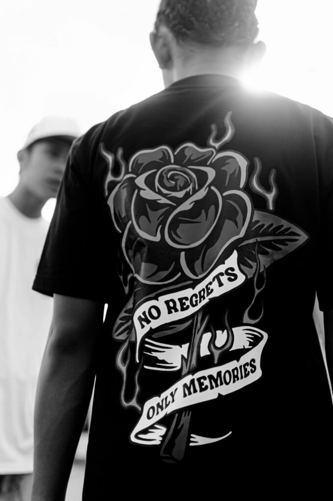 Black and white photo of stylish t-shirt featuring bold no regrets design.